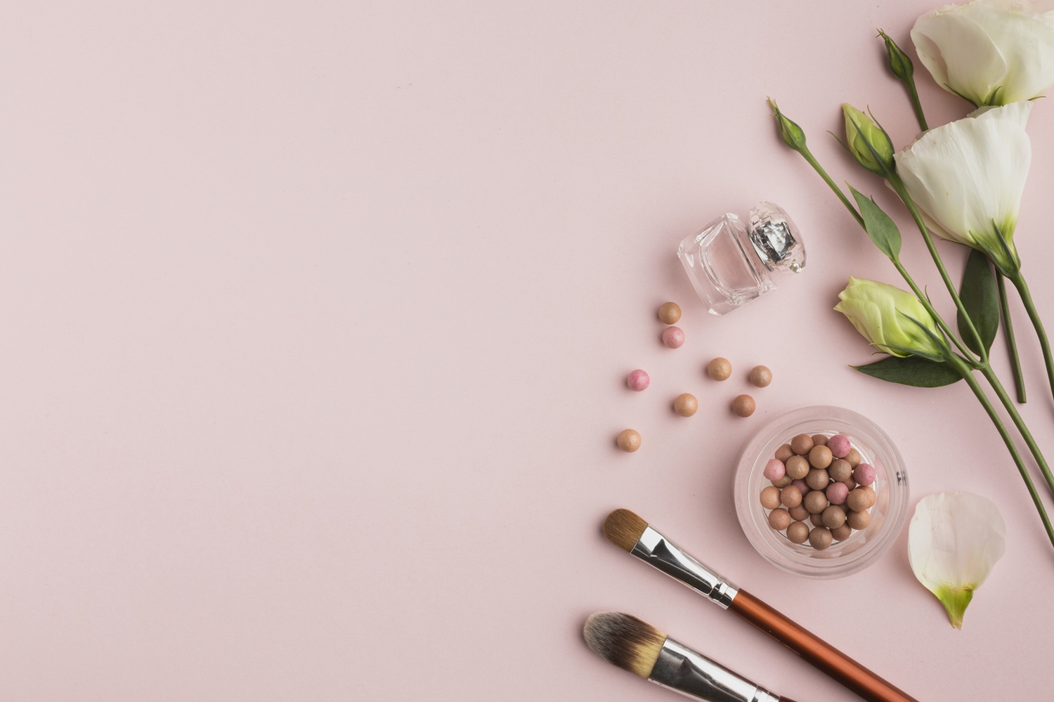 flat lay frame with make up products flowers